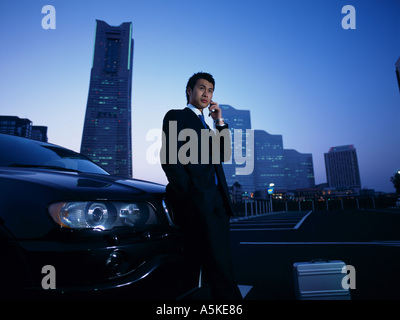 Asian Man talking on a cell phone Stock Photo