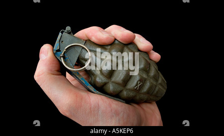 Hand grasping a hand grenade Familiar pineapple form M21 grenade Stock Photo