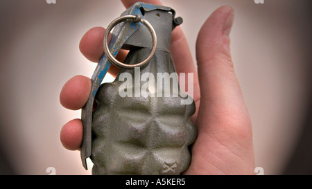Hand grasping a hand grenade Familiar pineapple form M21 grenade USA Stock Photo