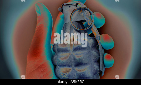 Hand grasping a hand grenade Familiar pineapple form M21 grenade USA Solarised effect Stock Photo