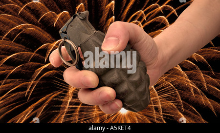 Hand grasping a hand grenade Familiar pineapple form M21 grenade USA Background exploding in streaks of flame Stock Photo