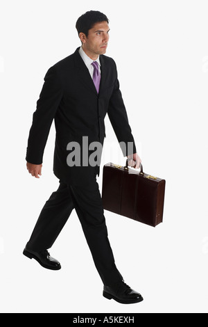 Businessman carrying briefcase Stock Photo