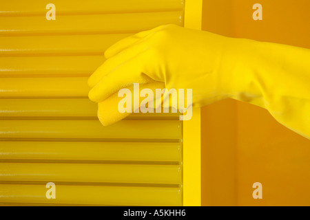 Cleaning a yellow cabinet Stock Photo