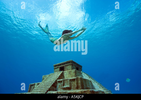Mermaid freediving over Mayan temple west side Cozumel Mexico Stock Photo