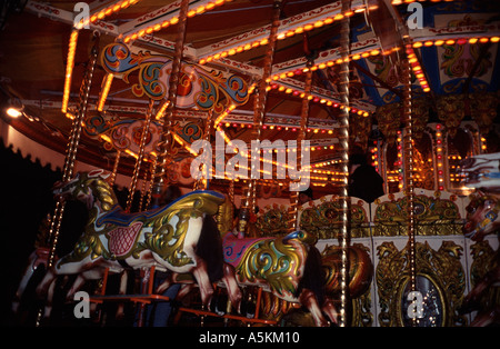Old style carousel with horses on a fairground ride, Bath, England UK Stock Photo
