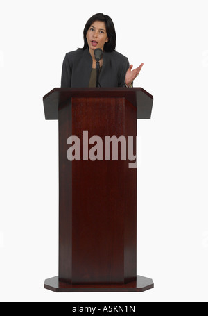 Businesswoman speaking at podium Stock Photo