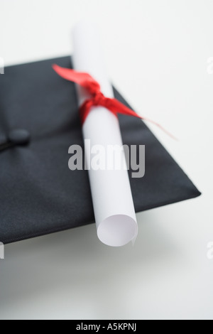 Close up of diploma and graduation cap Stock Photo