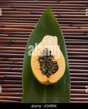 Close up of cut open fruit on leaf Stock Photo