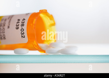 Close up of pills spilling out of medication bottle