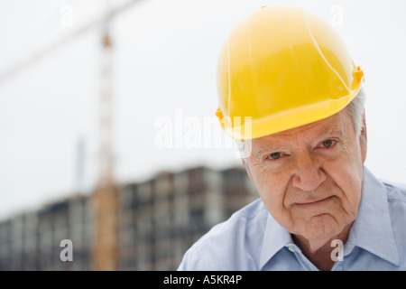 Senior man wearing hard hat Stock Photo