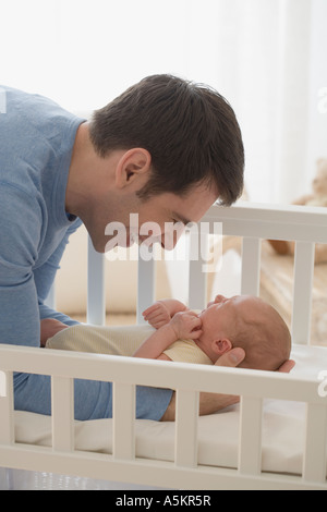 Father smiling at newborn baby Stock Photo