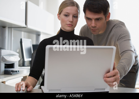 Businesspeople looking at laptop Stock Photo