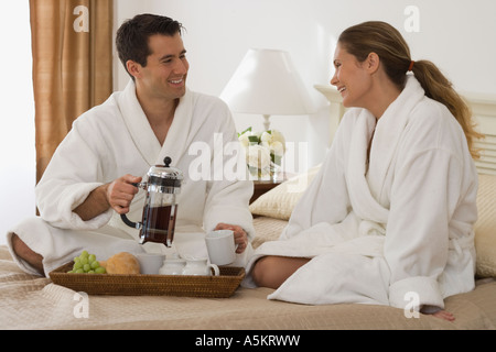 Couple eating breakfast in bed Stock Photo