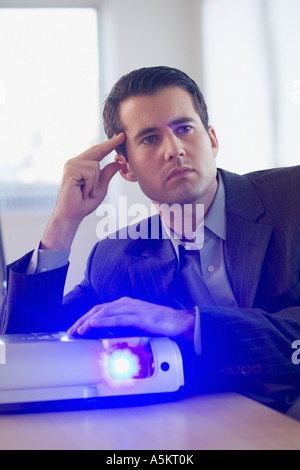 Businessman using projector in conference room Stock Photo