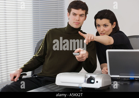 Businesspeople using projector Stock Photo