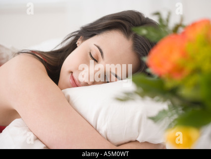 Woman sleeping in bed Stock Photo