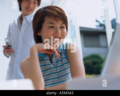 Asian Woman working on a laptop Stock Photo