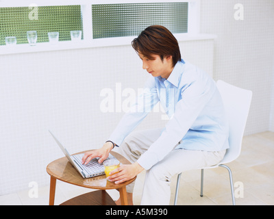 Asian man working on a laptop Stock Photo