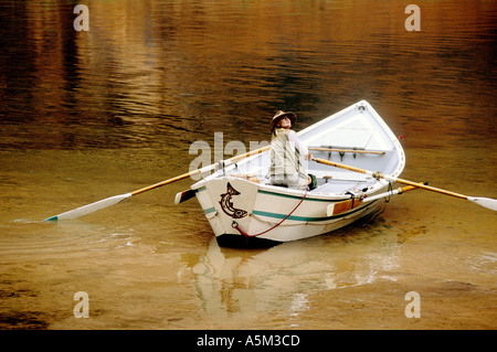 woman rowing a dory Stock Photo