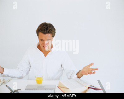 Caucasian sitting on a desk Stock Photo