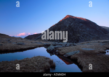 Pen yr Ole Wen in the last rays of sunlight seen from the drainage stream of Llyn Idwal Snowdonia National Park Gwynedd Wales Stock Photo
