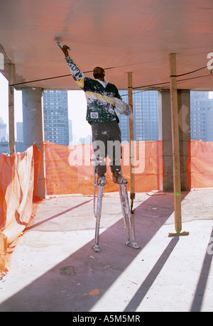 Plasterer works on ceiling of high end condominium in top half of Random House  building at 1745 Broadway in NYC. Stock Photo