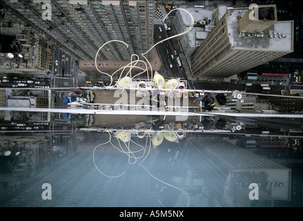 View of workers installing yellow caulk ropes on curtain wall at Random House building in New York City. Stock Photo