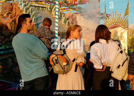 Young people in front of a traditional roundabout on the Oktoberfest 2003 Munich Bavaria Germany Editorial use only  Stock Photo