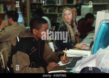 High school students work at computers doing homework at school library in New York City Stock Photo