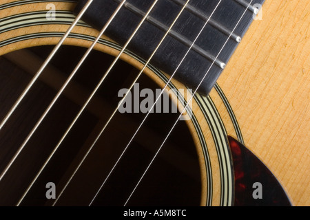 Close up of a Martin D 28 acoustic guitar showing the sound hole fret board strings and pick guard Stock Photo