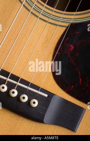 Close up of a Martin D 28 acoustic guitar showing the bridge strings sound hole and pick guard Stock Photo