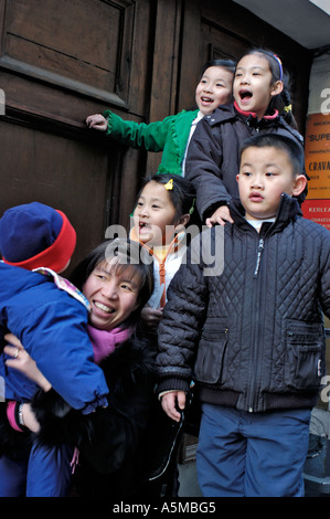 Paris France,  Families with Children, outside, Celebrating Chinese New Years on Street Festival, Happy Portrait Group Kids, Dragon Dance Stock Photo