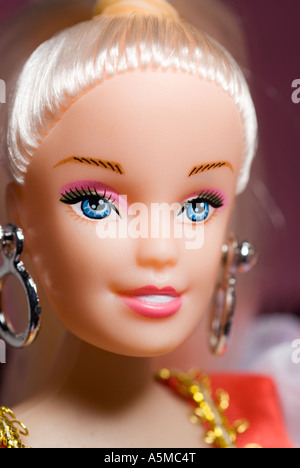 close-up doll face wearing big silver earings portrait Stock Photo