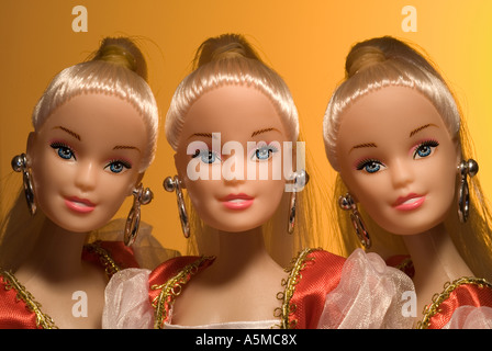 three dolls head and shoulders studio shot wearing party desses Stock Photo