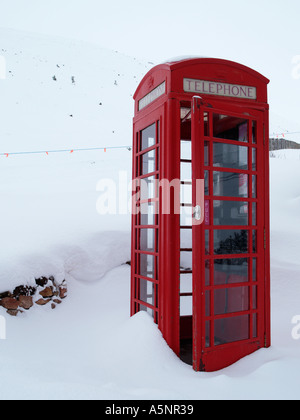 Old fashioned red telephone box K6 with door open in deep winter snow on Cairngorm mountain Cairn Gorm Highland Scotland UK Stock Photo