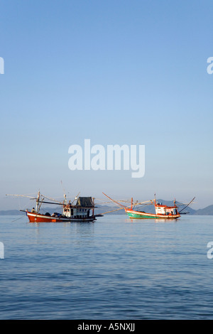 Traditional Thai Fishing Boats at Dawn light or sunrise   The Andaman Sea Krabi Beach resort, Krabi Province Thailand Stock Photo