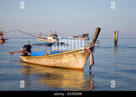 Longtailed fishermans Boat moored on still Andaman sea Krabi Beach Resort Krabi Province Southern Thailand Stock Photo