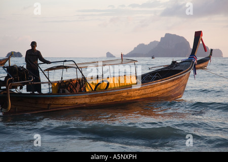 Long tail boats on Railay or Railey beach lagoon, Krabi Province Andaman Sea, Thailand, at sunset. Stock Photo