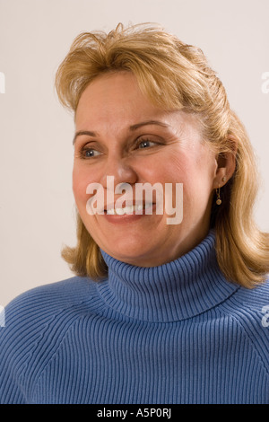 Portrait of a middle aged woman.She is smiling and looks to be very positive. Stock Photo