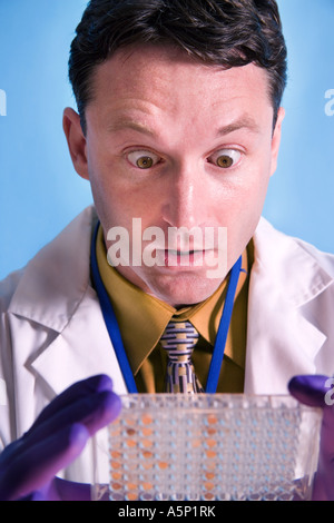 Medical - Science researcher is surprised by samples he is working with. Stock Photo