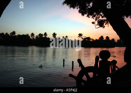 Stunning calm sunset from a moored houseboat on the backwaters of Kerala Stock Photo