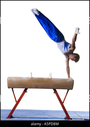 Male gymnast performing routines on vaulting horse Stock Photo