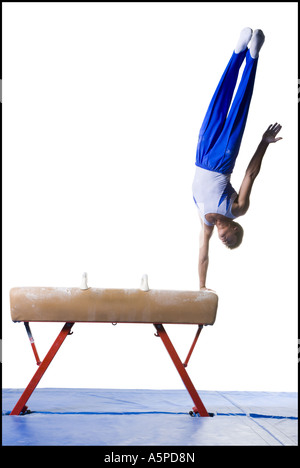 Male gymnast performing routines on vaulting horse Stock Photo