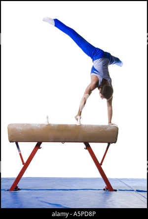 Male gymnast performing routines on vaulting horse Stock Photo