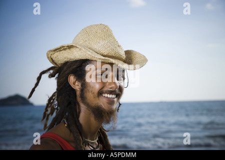 Close-up of a young man wearing a straw hat Stock Photo