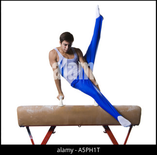 Male gymnast performing routines on vaulting horse Stock Photo