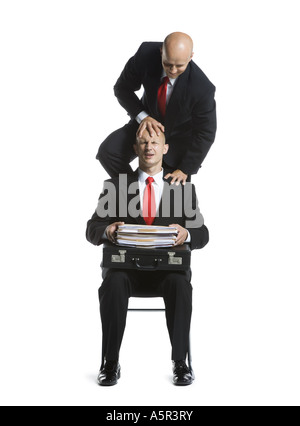 Two male acrobats in business suits performing Stock Photo