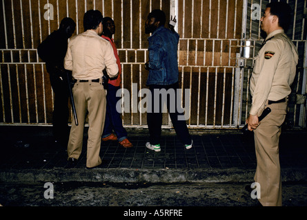 ILLEGAL IMMIGRANTS POLICE SEARCHING WEST AFRICANS FOR DRUGS ON NIGHT PATROL ON THE STREETS OF LAS PALMAS CANARY ISLANDS, SPAIN Stock Photo