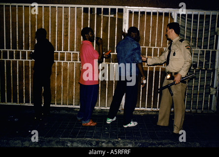 ILLEGAL IMMIGRANTS POLICE SEARCHING WEST AFRICANS FOR DRUGS ON NIGHT PATROL ON THE STREETS OF LAS PALMAS CANARY ISLANDS, SPAIN Stock Photo