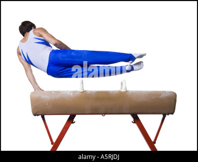 Male gymnast performing on vaulting horse Stock Photo